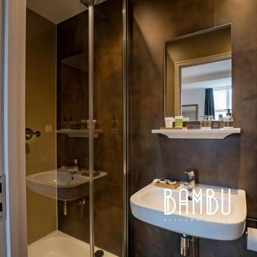 a bathroom with a sink and a shower at Bambu Kitchen & Bar - Hotel Restaurant in Haarlem