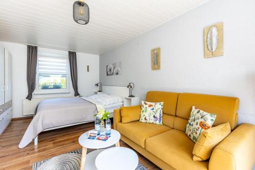 a living room with a couch and a bed at Sonnenblumenhaus 01 in Prerow