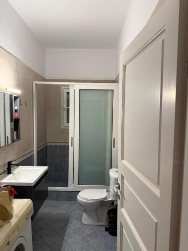 a bathroom with a toilet and a sink and a shower at Kalloni Village House in Kalloní