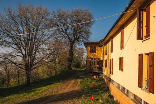 an old house next to a dirt road with trees at Debre Mariam Guest House in Bologna