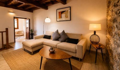 a living room with a couch and a table at Casa Rural La Eugenia · Picos de Europa · Cabrales in Puertas
