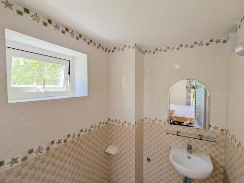 a bathroom with a sink and a mirror at AN Apartment in Danang