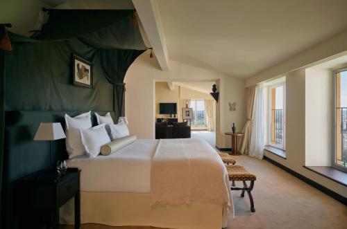 a bedroom with a large bed and a living room at Villa Florentine, A Beauvallon Hotel & Spa in Lyon