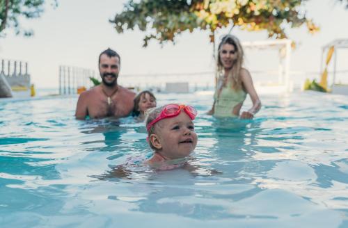 a group of people in a swimming pool at ZAN Uhuru Beach in Jambiani