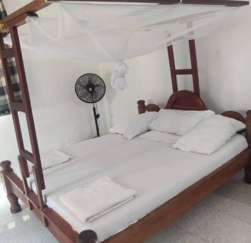 a bedroom with a bunk bed with a fan at Kwetu nungwi in Kinyasini