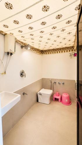 a bathroom with a toilet and a sink at Unity Sunrise Resort Statue of Unity Ekta Nagar in Kevadia