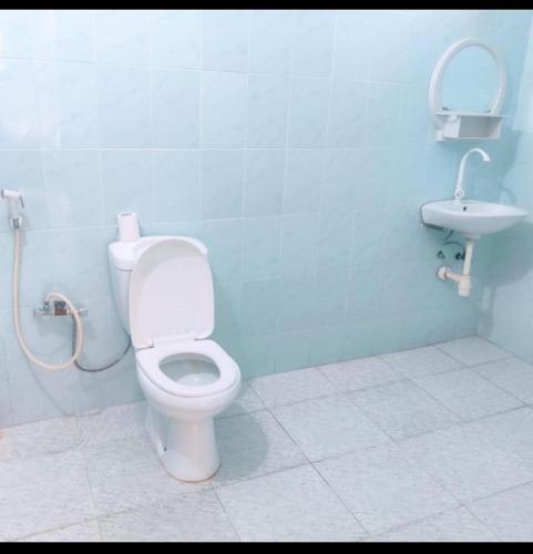a bathroom with a toilet and a sink at Kwetu nungwi in Kinyasini