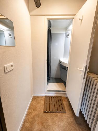 a small bathroom with a toilet and a sink at 1861 Châtel Hostel in Châtel