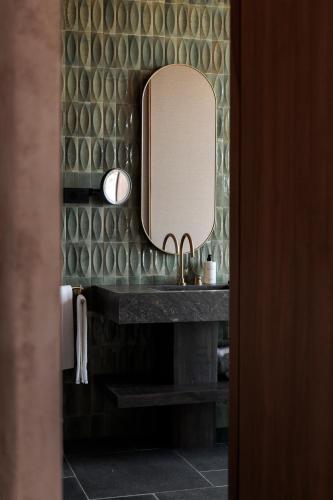 a bathroom with a sink and a mirror at Icona's Costa Ragusa Resort - New Opening in Scoglitti