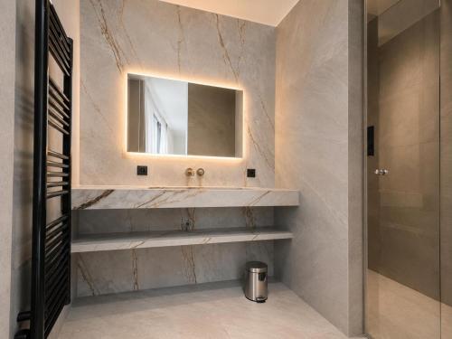 a bathroom with a sink and a mirror at Logis Hôtel Restaurant & Spa au Soleil in Wettolsheim