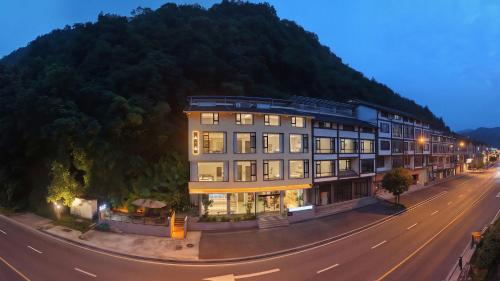 a large building on the side of a road at Mountain Luxury Courtyard Hotel-Zhangjiajie Wulingyuan National Forest Park-Laundry Service,coffee&Chinese Tea--Free airportpick-up or drop-off for Reserve of 4nights or more in Zhangjiajie