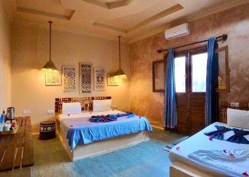 a bedroom with two beds in a room at Ocean Breeze Boutique Hotel in Nungwi