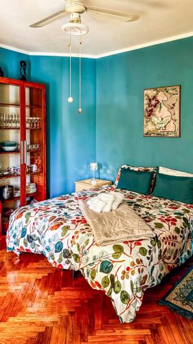 a bedroom with blue walls and a bed at Moon's House Oropa in Biella