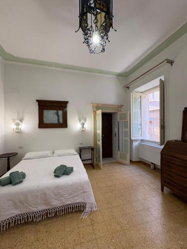 a large bedroom with a bed and a chandelier at Atelier Peretti in Alghero