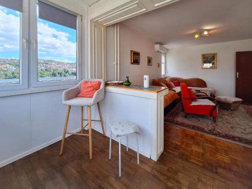 a living room with a bar with a view at Apartman Pasic in Sarajevo