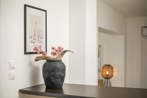 a vase with pink flowers sitting on a table at Casa Evita in Gennadi