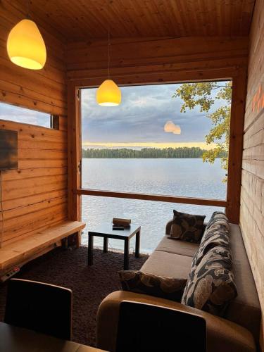 a room with a bed and a view of a lake at Kyly in Savonlinna