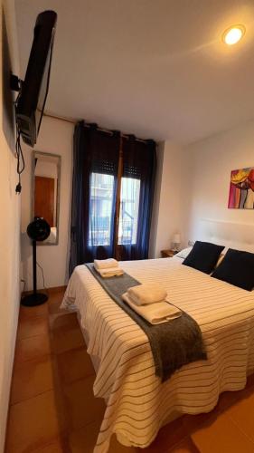 a bedroom with a large bed with towels on it at V.U.T. EL HONGO in Mora de Rubielos