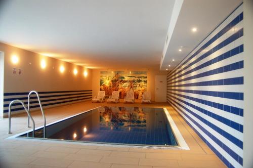 a pool in the middle of a house at Sun Island in Baabe
