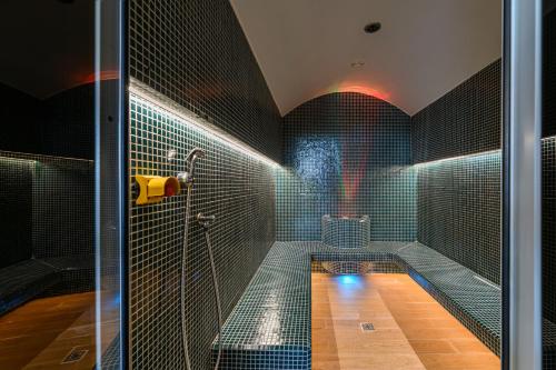 a bathroom with a bath tub with a shower at Complex Hotelier COTA O MIE in Sinaia
