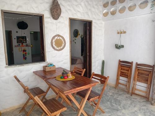 a dining room with a wooden table and chairs at Chale Canoa Beach in Canoa Quebrada