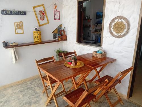a wooden table and chairs in a room at Chale Canoa Beach in Canoa Quebrada