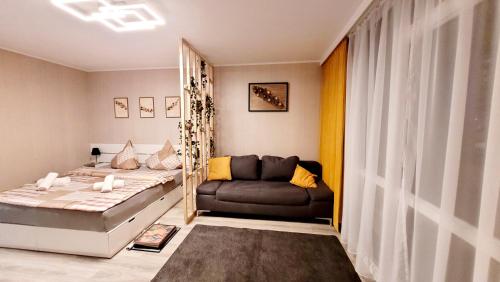 a bedroom with a bed and a couch in it at Modernes Wohlfühl-Apartment mit Stil in Mülheim an der Ruhr