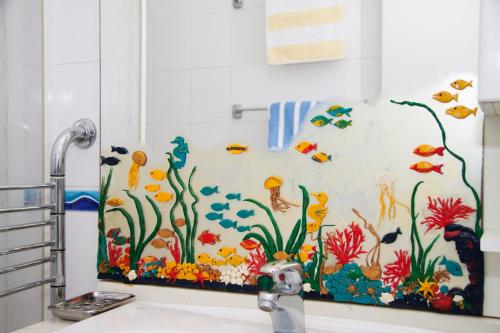 a bathroom with a shower curtain with an underwater mural at Apartments Sundance in Okrug Donji