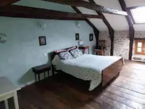 a bedroom with a large bed in a room at maison d'hôtes in Rouffiac