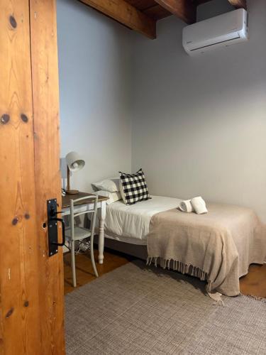 a room with two beds and a table and a chair at Elianthe Boutique Guesthouse in Swellendam