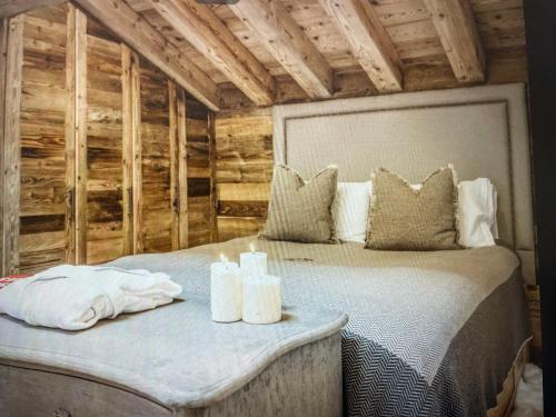 a bedroom with a bed in a room with wooden walls at Crystal Lodge St Moritz in St. Moritz