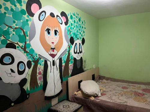 a bedroom with pandas painted on the wall at Махамбета in Atyrau