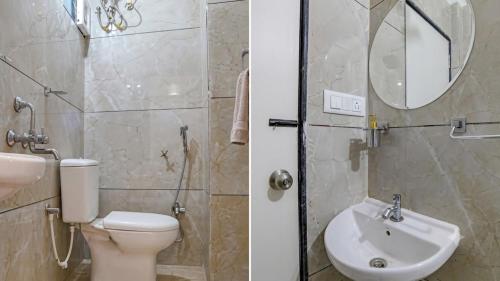a bathroom with a toilet and a sink and a mirror at homly hotel in Indore