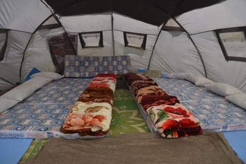 a large tent with two beds in it at Hello Rakaposhi Camping Site in Gilgit
