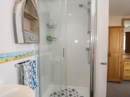 a bathroom with a shower and a sink at Roma in Rhos-on-Sea