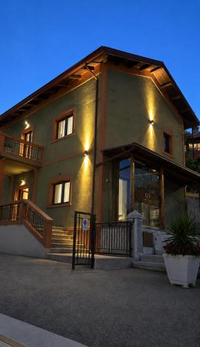 a large building with a sign in front of it at B&B Casa Claudio in San Giovanni Rotondo