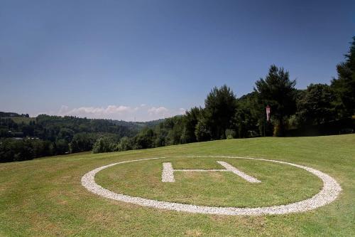 a clock on a grassy hill in a field at Villa Cattani Stuart XVII secolo in Pesaro