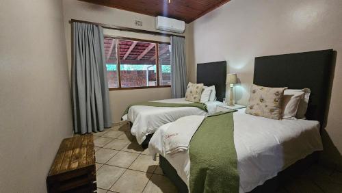 a bedroom with two beds and a window at Fisherman's 6-Bedroom Family Home in St Lucia