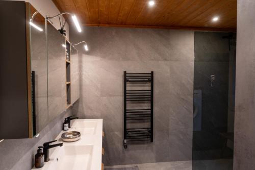 a bathroom with a sink and a shower at Luxury Chalet with Swimming Pond Nature Escape Upper Austria in Sankt Johann am Walde