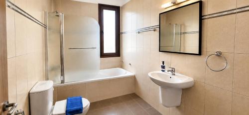 a bathroom with a toilet and a sink and a shower at Palm Tree Villa By Staycom in Oroklini