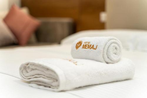 a white towel sitting on top of a bed at Moncler Residence in Ksamil