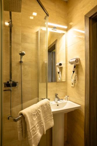 a bathroom with a sink and a shower at Art хостел-готель "Адреналін" in Lutsk