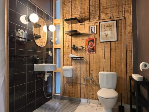 a bathroom with a toilet and a sink at Room 0 in The White House Residence in Kuldīga