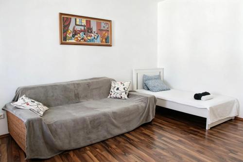 a living room with a couch and a table at Heritage Courtyard Apartment in Bruck an der Leitha