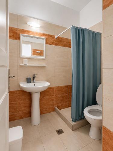 a bathroom with a sink and a toilet and a shower at Anny Studios & Rooms Perissa Beach in Perissa