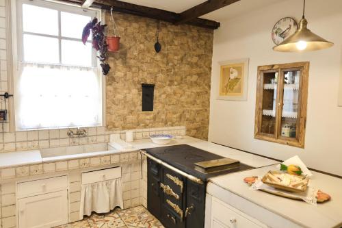 a kitchen with a sink and a stove top oven at Casa da Juana in Chantada