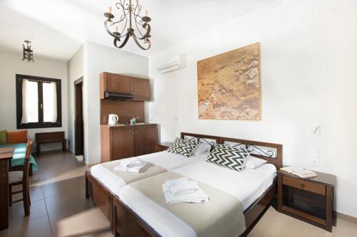 a bedroom with a bed and a dining room at Poseidon Hotel in Meyisti