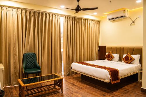 a hotel room with a bed and a green chair at DEO SIGNATURE SUITE Hotel in Rānchī