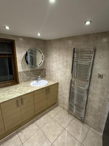a bathroom with a sink and a shower at PLUS PROPERTIES Leeds 6 in Bradford