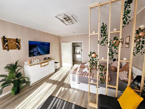 a bedroom with a canopy bed and a bathroom at Modernes Wohlfühl-Apartment mit Stil in Mülheim an der Ruhr